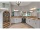 Spacious primary bathroom with double vanities, decorative lighting, mirrors, and a decorative cabinet at 9512 Mid Summer Ln, Leesburg, FL 34788