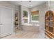 Bathroom featuring a tub with tile surround, a built-in display niche, and white cabinetry at 9512 Mid Summer Ln, Leesburg, FL 34788