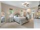 Cozy bedroom featuring neutral tones, carpet, a ceiling fan, and two windows at 9512 Mid Summer Ln, Leesburg, FL 34788