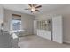 Inviting bedroom space with a large window, storage, study space, and great natural light at 9512 Mid Summer Ln, Leesburg, FL 34788