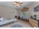 Neutral tone bedroom with large window, storage shelving and plenty of space for activities at 9512 Mid Summer Ln, Leesburg, FL 34788