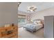 Comfortable bedroom with natural light, featuring a ceiling fan, decorative accents, and a peaceful atmosphere at 9512 Mid Summer Ln, Leesburg, FL 34788