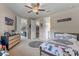 Neutral toned bedroom with Star Wars decor, walk-in closet, and ensuite bathroom at 9512 Mid Summer Ln, Leesburg, FL 34788