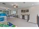 Upstairs bonus room with plenty of space for entertainment with a drink cooler and mini-bar at 9512 Mid Summer Ln, Leesburg, FL 34788