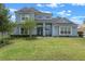 Beautiful two-story home featuring a lush green lawn and attractive landscaping that adds great curb appeal at 9512 Mid Summer Ln, Leesburg, FL 34788