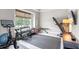 Bright home gym with equipment including a treadmill, weights, and stationary bike at 9512 Mid Summer Ln, Leesburg, FL 34788