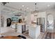 Bright and open kitchen featuring stainless steel appliances, white cabinetry, and a center island with counter seating at 9512 Mid Summer Ln, Leesburg, FL 34788