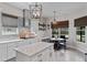 Bright kitchen featuring stainless steel appliances, white cabinets, a kitchen island and a cozy breakfast nook at 9512 Mid Summer Ln, Leesburg, FL 34788
