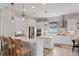 Modern kitchen featuring white cabinets, stainless steel appliances, and a center island with counter seating at 9512 Mid Summer Ln, Leesburg, FL 34788
