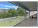 Lanai with a view of a well-maintained backyard and a seating area for enjoying the outdoors at 9512 Mid Summer Ln, Leesburg, FL 34788