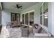 Covered lanai features a cozy outdoor seating area and dining space, perfect for entertaining guests at 9512 Mid Summer Ln, Leesburg, FL 34788