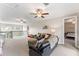 Spacious living room with carpet and comfortable leather furniture at 9512 Mid Summer Ln, Leesburg, FL 34788