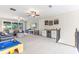 Open living room with carpet, ceiling fans, and access to the patio at 9512 Mid Summer Ln, Leesburg, FL 34788
