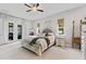 Bright and airy main bedroom features a ceiling fan, windows, and access to a backyard view at 9512 Mid Summer Ln, Leesburg, FL 34788