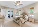 Bright main bedroom with neutral tones, carpet, ceiling fan, and access to the backyard at 9512 Mid Summer Ln, Leesburg, FL 34788