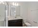Modern bathroom featuring a large mirror, a dark vanity, sleek fixtures, and a glass-enclosed shower at 9674 Rodbell St, Orlando, FL 32827