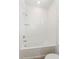 Bathroom showcasing a white tiled tub and shower combination, providing a clean and modern aesthetic at 9674 Rodbell St, Orlando, FL 32827