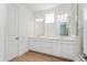 Contemporary bathroom boasts double sinks, modern lighting, and a glass-enclosed shower with neutral color palette at 9674 Rodbell St, Orlando, FL 32827