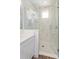 Stylish bathroom showcases a frameless glass shower enclosure with marble tile and updated fixtures at 9674 Rodbell St, Orlando, FL 32827