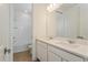 Well-lit bathroom with double vanity, quartz countertop, and tiled shower/tub combination in the background at 9674 Rodbell St, Orlando, FL 32827