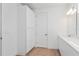 Well-lit bathroom features ample storage with a tall cabinet, a long vanity, and neutral color scheme at 9674 Rodbell St, Orlando, FL 32827
