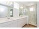 Bright bathroom features a double vanity, modern fixtures, and a large glass-enclosed shower with marble-style tile at 9674 Rodbell St, Orlando, FL 32827