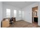 Bright bedroom featuring three windows offering an outside view, a closet, and a connected bathroom at 9674 Rodbell St, Orlando, FL 32827