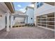 An exterior view of the home showing the driveway and the side of the house featuring a covered patio at 9674 Rodbell St, Orlando, FL 32827