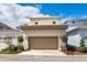 Exterior view of the home featuring a two-car garage with decorative landscaping and lawn in front at 9674 Rodbell St, Orlando, FL 32827
