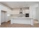 Modern kitchen with stainless steel appliances, white cabinets and a center island with quartz countertop at 9674 Rodbell St, Orlando, FL 32827