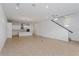 Open concept living area featuring tile flooring, recessed lights, and a modern kitchen island at 9674 Rodbell St, Orlando, FL 32827