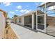 Exterior shot of the home's backyard featuring a concrete patio and screened-in lanai at 997 Oscar Ln, The Villages, FL 32162