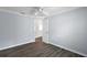 Bedroom featuring a doorway, hardwood flooring, fresh paint, and a ceiling fan at 997 Oscar Ln, The Villages, FL 32162