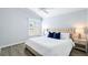 Comfortable bedroom featuring a queen-size bed, accent pillows, bedside tables and lamps at 997 Oscar Ln, The Villages, FL 32162