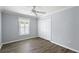 Bedroom features a closet, hardwood flooring, fresh paint, window with shutter, and ceiling fan at 997 Oscar Ln, The Villages, FL 32162