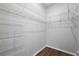 Walk-in closet featuring metal shelving and wood-look floors at 997 Oscar Ln, The Villages, FL 32162
