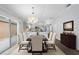 This modern dining area adjacent to the kitchen and living room features ample seating at 997 Oscar Ln, The Villages, FL 32162