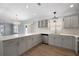 This modern kitchen features stainless steel appliances and stone countertops, perfect for cooking and entertaining at 997 Oscar Ln, The Villages, FL 32162