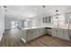 Open floor plan with stylish kitchen leading into living room area with sliding door at 997 Oscar Ln, The Villages, FL 32162