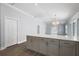 Open concept kitchen and living room features wood look floors at 997 Oscar Ln, The Villages, FL 32162
