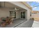 Spacious covered patio with ceiling fan, outdoor seating and sliding glass doors at 997 Oscar Ln, The Villages, FL 32162