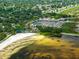 Aerial view showcases waterfront marina, beach and restaurant amenities nestled amongst mature trees and waterways at 101 Lakeshore Blvd, St Cloud, FL 34769