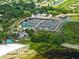 Aerial view showcases waterfront marina, beach and restaurant amenities nestled amongst mature trees and waterways at 101 Lakeshore Blvd, St Cloud, FL 34769