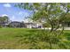 Expansive backyard with screened pool, garage, and lush green lawn at 101 Lakeshore Blvd, St Cloud, FL 34769