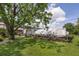Backyard showcasing green space, greenhouse, and shed with ample storage at 101 Lakeshore Blvd, St Cloud, FL 34769