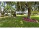 Beautiful backyard with mature landscaping, pool and play set in the distance at 101 Lakeshore Blvd, St Cloud, FL 34769