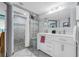 Bathroom with double sink vanity, large mirror, and glass block shower at 101 Lakeshore Blvd, St Cloud, FL 34769