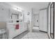 Spacious bathroom has double sinks, large mirror, and white tile flooring at 101 Lakeshore Blvd, St Cloud, FL 34769