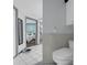 Bathroom with white tile floor, toilet, and view into bedroom at 101 Lakeshore Blvd, St Cloud, FL 34769