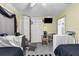 Bedroom with two beds, ceiling fan, and closet featuring gray chair and TV at 101 Lakeshore Blvd, St Cloud, FL 34769
